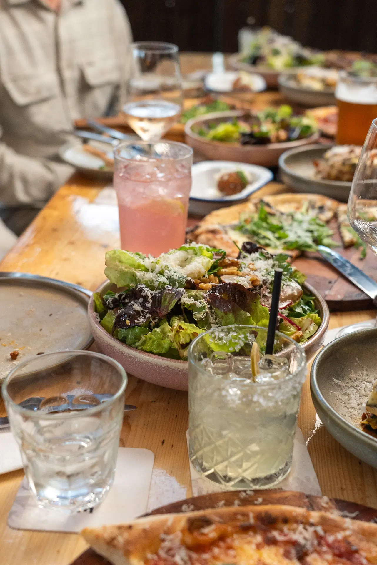 Seasonal salad and drinks on a shared table