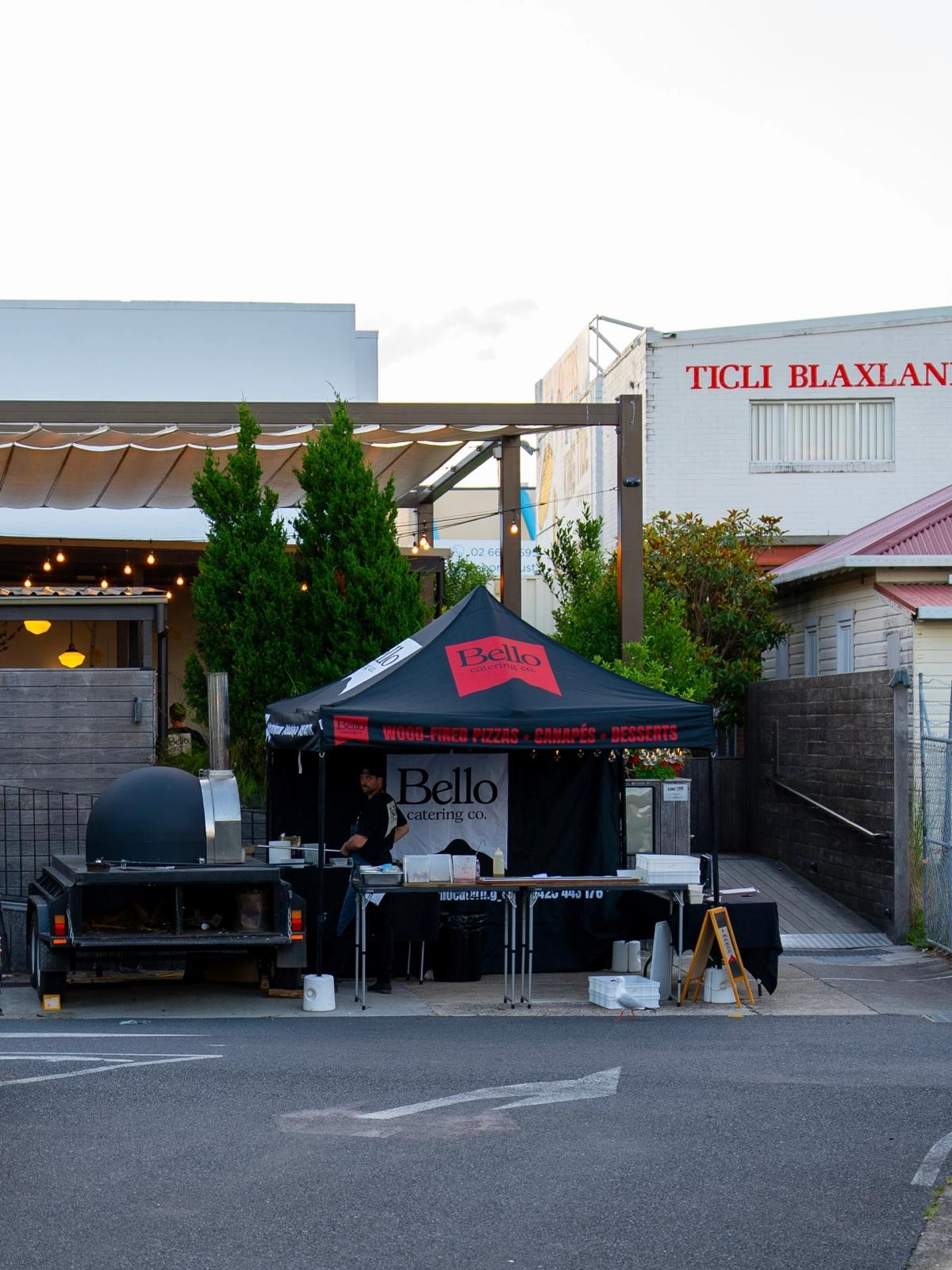 Bello branded pop-up pizza stall and oven trailer set up outdoors