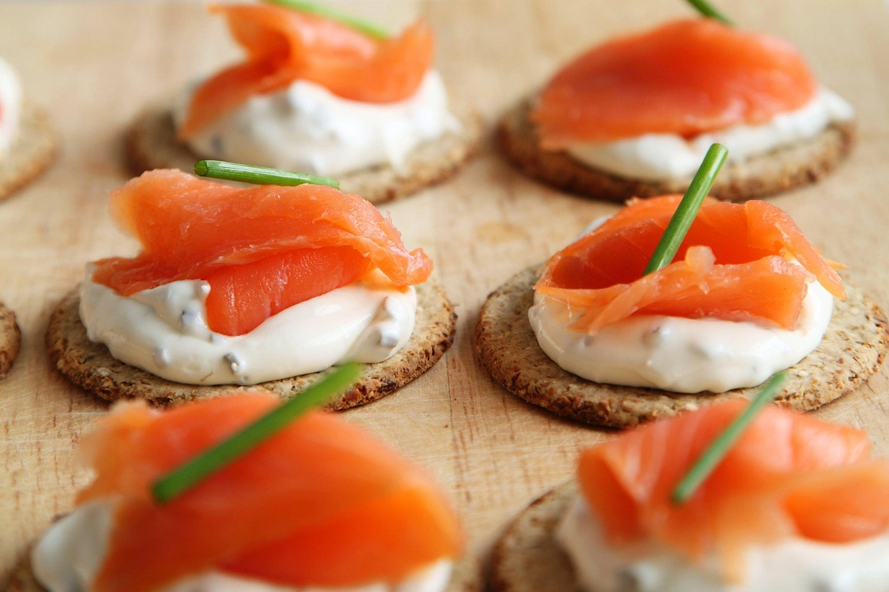 Smoked salmon canapés on oat crackers with chives
