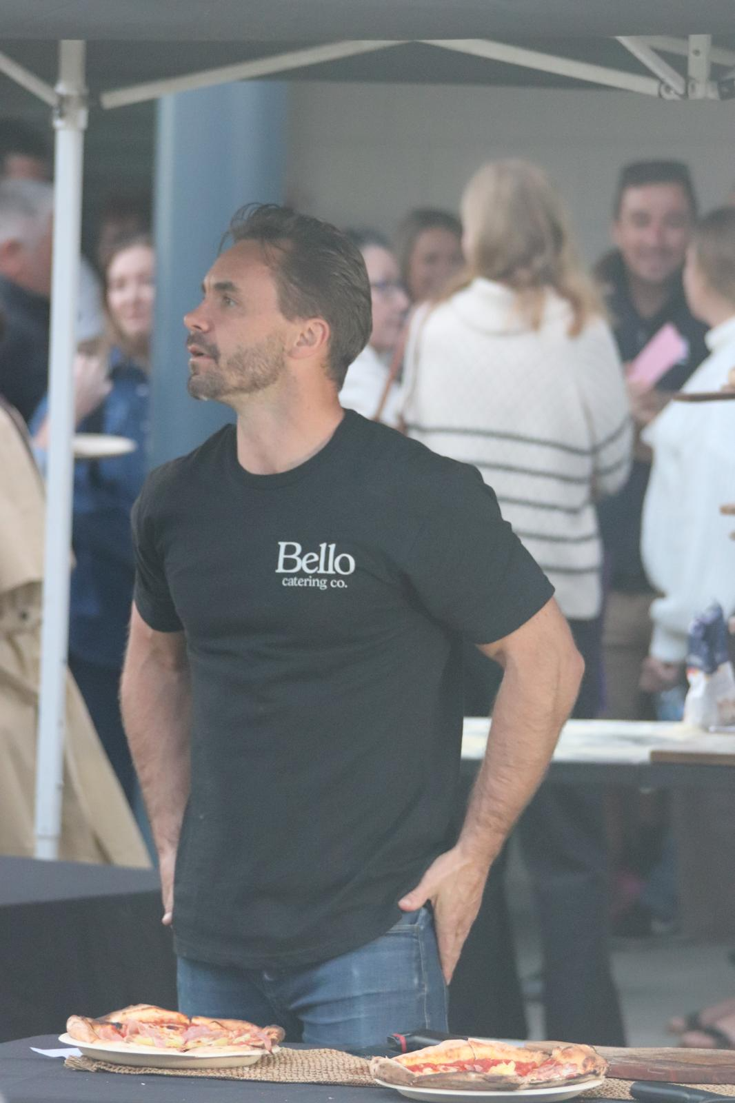 Callum in a Bello Catering Co. tee at an event with wood-fired pizzas