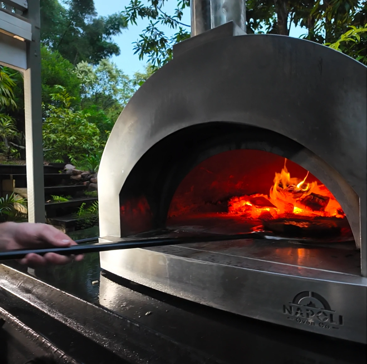 Wood-fired oven burning at a Bello event