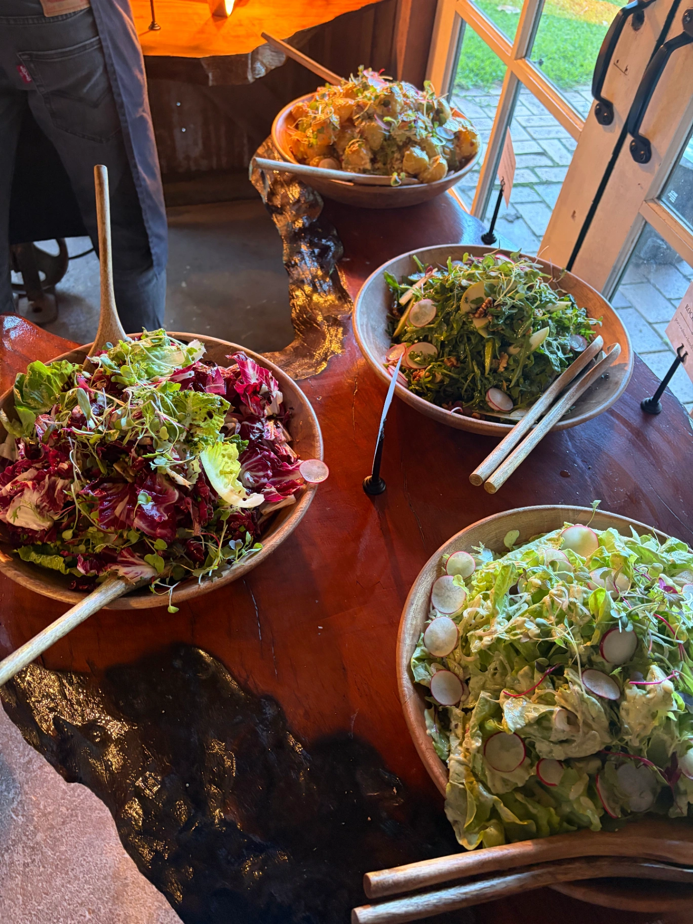 Fresh seasonal salad bowls served alongside the shared banquet